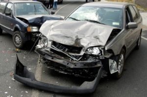 Two heavily damaged vehicles after a car accident