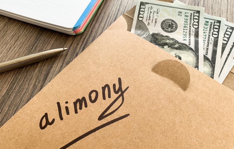 A brown envelope with money, with the word “alimony” written on it