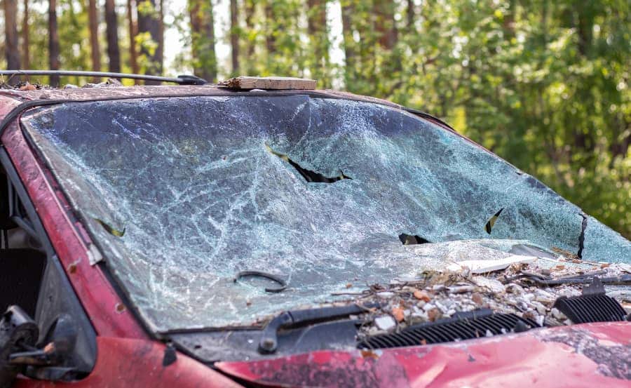 Close-up of a car with a broken windshield after a fatal crash.